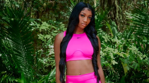 Angel Reese models pink Reebok apparel.